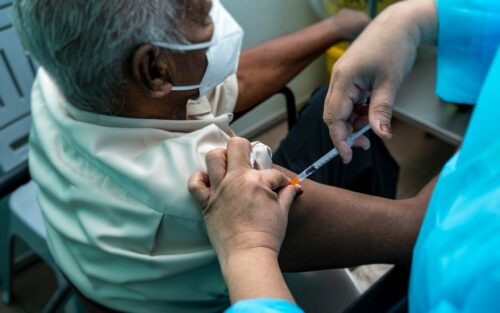 An elderly person getting vaccinated