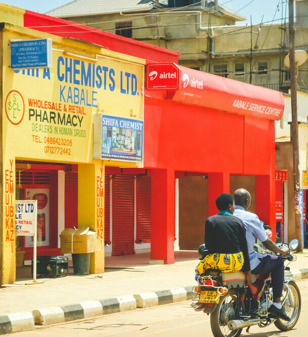 Motorcycle driving by a pharmacy in Uganda