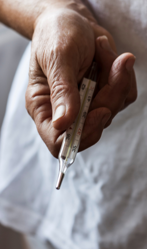 hand holding a thermometer