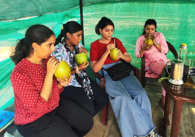 The team enjoying fresh coconut water 