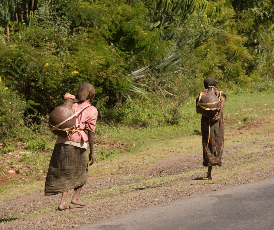 Women carrying water, walking barefoot